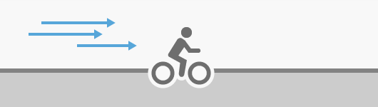 A bicyclist pedaling with a tailwind A bicyclist pedaling with a tailwind
